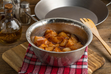 Chunks of chicken in marinade.