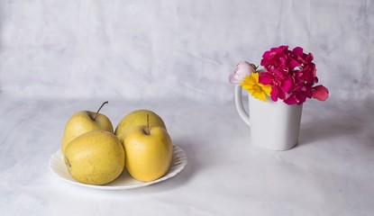 Apples  and flowers on the table