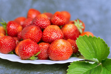 Juicy red strawberries on a plate