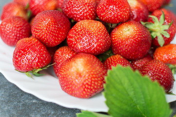 Juicy red strawberries on a plate