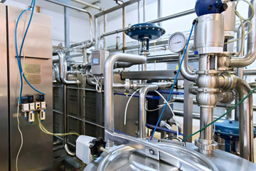 Industrial dairy production. View on the steel pipelines on the milk factory.