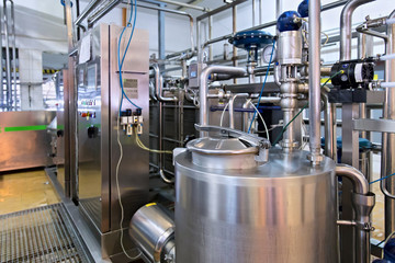 Industrial dairy production. View on the steel pipelines on the milk factory.