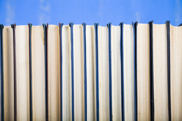 Stack of books on a blue background.