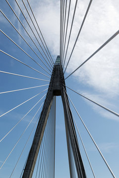 Suspension bridge against blue and cloudy sky