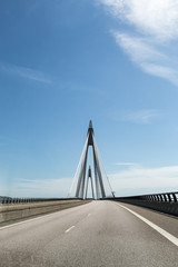 Suspension bridge against blue and cloudy sky