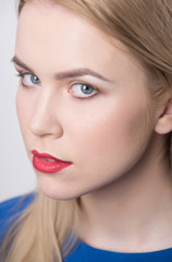 Girl with red lips and professional makeup on adorable face