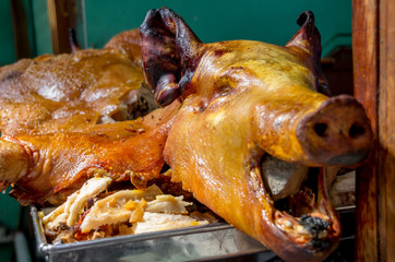 Delicious hornado roasted pork, over a silver tray, ecuadorian traditional typical andean food located in the municipal market in San Francisco in the city of Quito