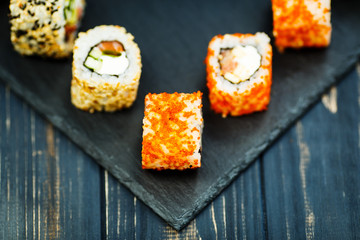 Japanese sushi on a rustic dark background