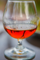 Cognac in a glass with grapes