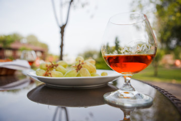 Cognac in a glass with grapes