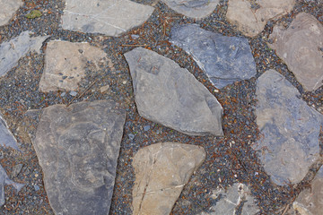 Texture of large and small stones of different colors.