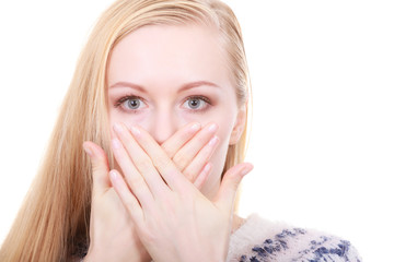 Shocked young woman covering mouth with hand