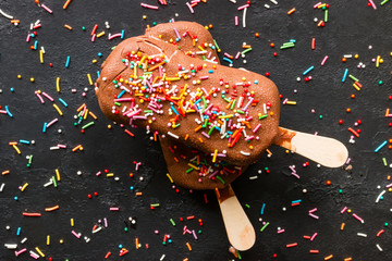 popsicle with multicolored sprinkles on a black background