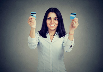 Happy debt free woman holding a credit card cut in two pieces