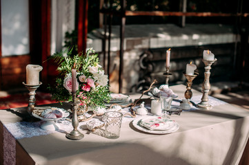 Candles with decor and flowers, peach, white and green color