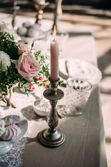 Candles with decor and flowers, peach, white and green color