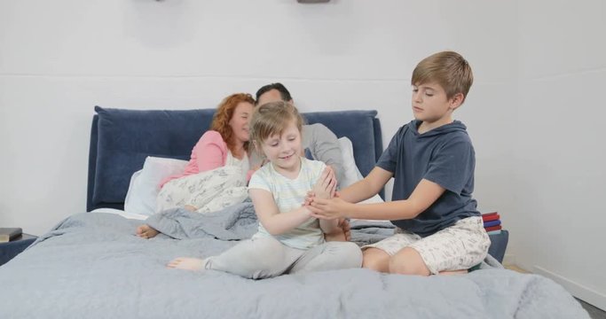 Family In Bedroom, Parents Using Cell Smart Phone While Children Play Together In Morning Concept Slow Motion 60