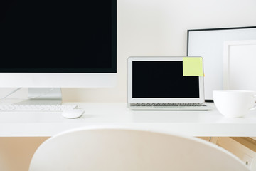 Designer desktop with pc and laptop closeup