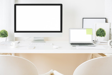 Designer desktop with computer and laptop front