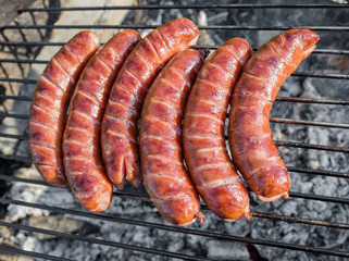 Grilling sausages on barbecue grill 