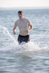 Fototapeta premium Teenage boy in the sea on a summer's day