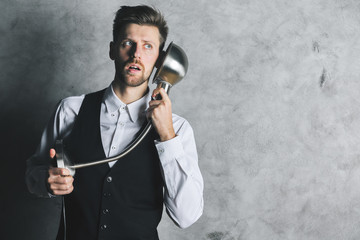 Naklejka premium Crazy businessman with lamp phone