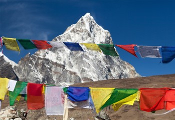 Rows of prayer flags and mount Arakam Tse