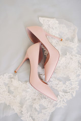 beige wedding shoes on a neutral light lacy background