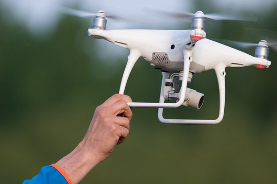 The men is catching dron in hend