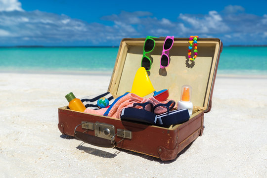 Beach Accessories In Suitcase On Beach - Travel Concept