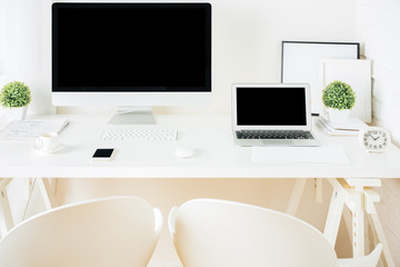 White hipster desktop with pc and notebook
