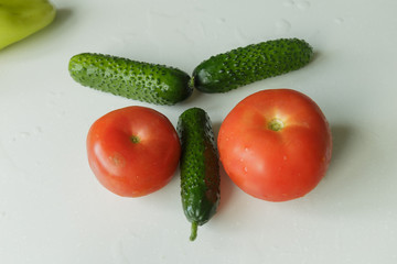 Vegan food. Vegetables for veggie breakfast. Cucumbers and tomatoes isolated on white background