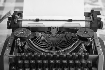 retro typewriter with blank sheet