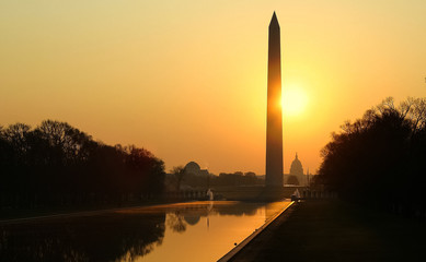 Sun rising behind the Washington Monument and Reflecting Pool
