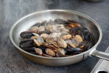 Clams and mussels on hot pan