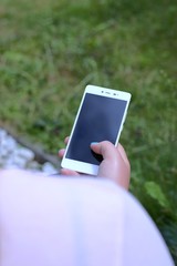Close up of a woman's hand using a smartphone,black screen
