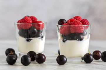 Black currant and raspberries with dairy products. Yogurt with fresh berries.