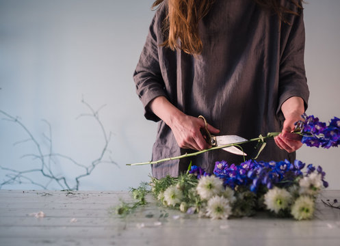 Midsection of woman cutting flowers