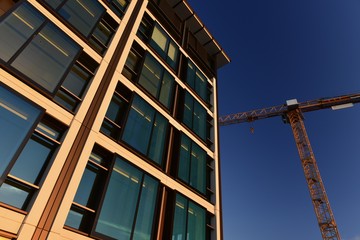 Office building, Jersey, U.K.  Wide angle image of a business building with a crane.