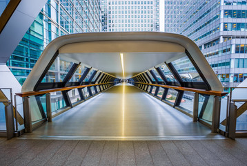 London, England - Public pedestrian cross rail footbridge at the financial district of Canary Wharf...