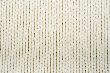Sweater or scarf fabric texture large knitting. Knitted jersey background with a relief pattern. Wool hand- machine, handmade.