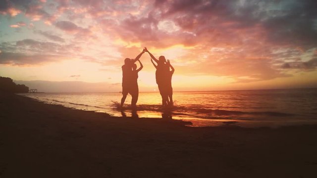 Group of friends celebrating on the beach.
