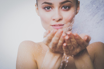 Young beautyful woman under shower in bathroom.