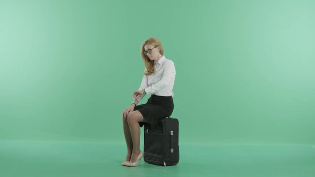 an exhausted woman sits on the luggage