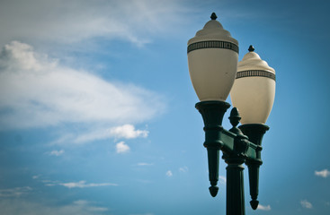 Low angle view of Classic lighting pole against blue sky