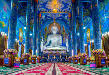 Blue buddhist temple and white buddha statue