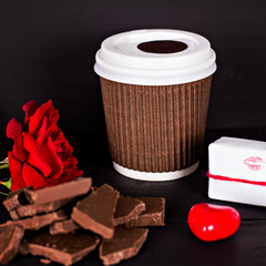 A glass of coffee, chocolate, a red rose, a gift.
