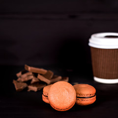 Classic French macaroons on a black background