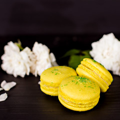 Classic French macaroons on a black background