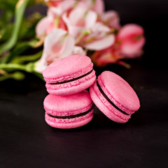 Classic French macaroons on a black background